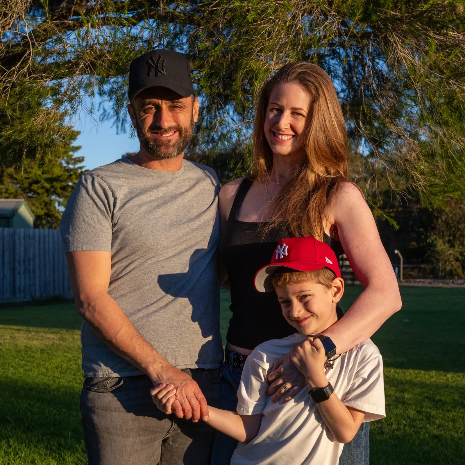 Chris, Kara and Zachary Pearce of Abode Productions under a tree at golden hour
