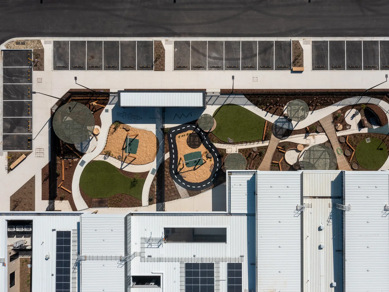 Aerial view of playgrounds and rooflines at 110-122 Unity Drive, Mount Duneed