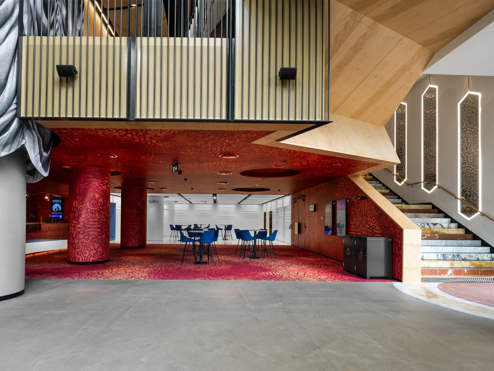 Foyer of the Geelong Arts Centre with red columns and timber ceiling