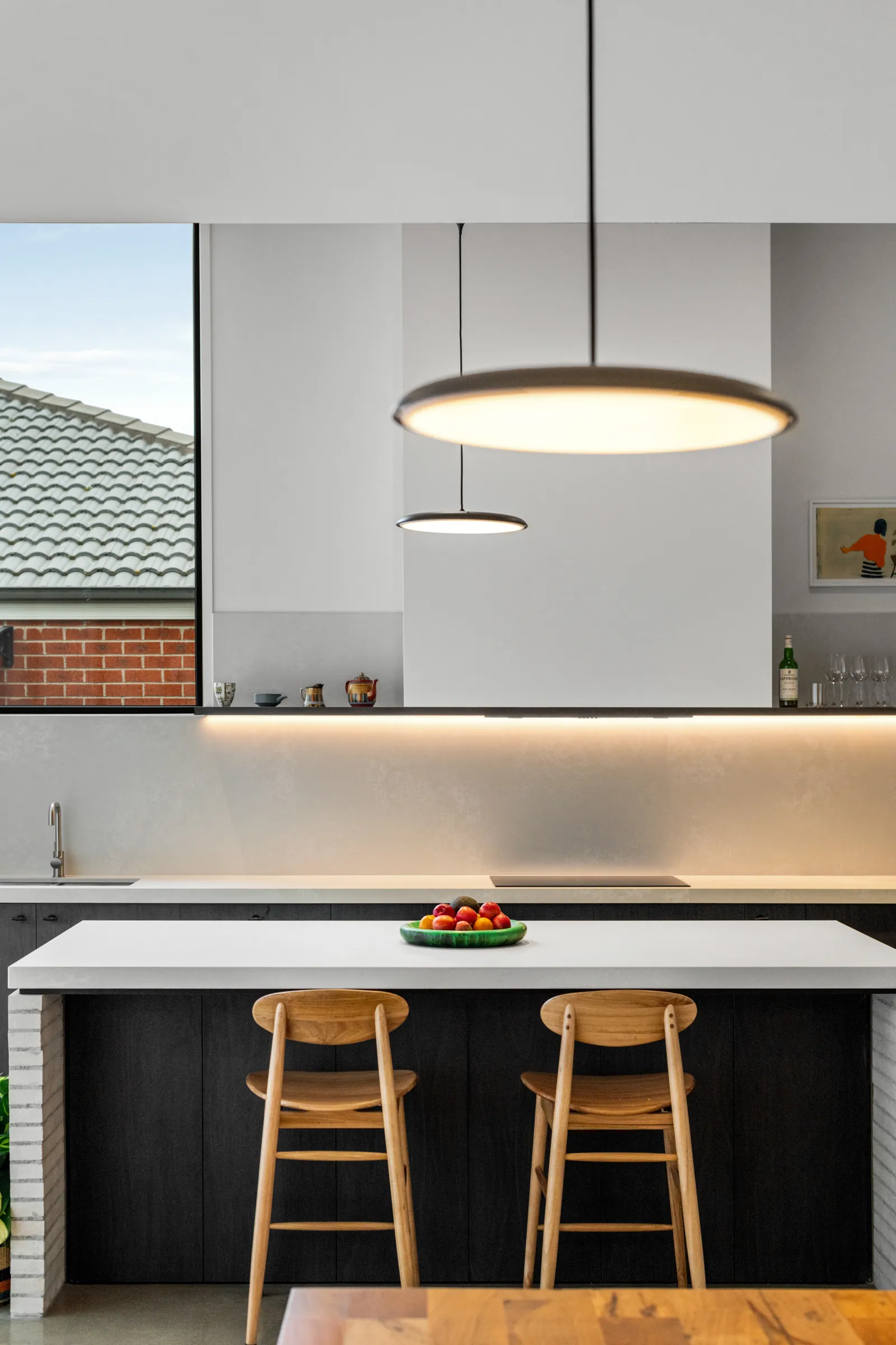 Kitchen island under a pendant light in a custom build at Queenscliff