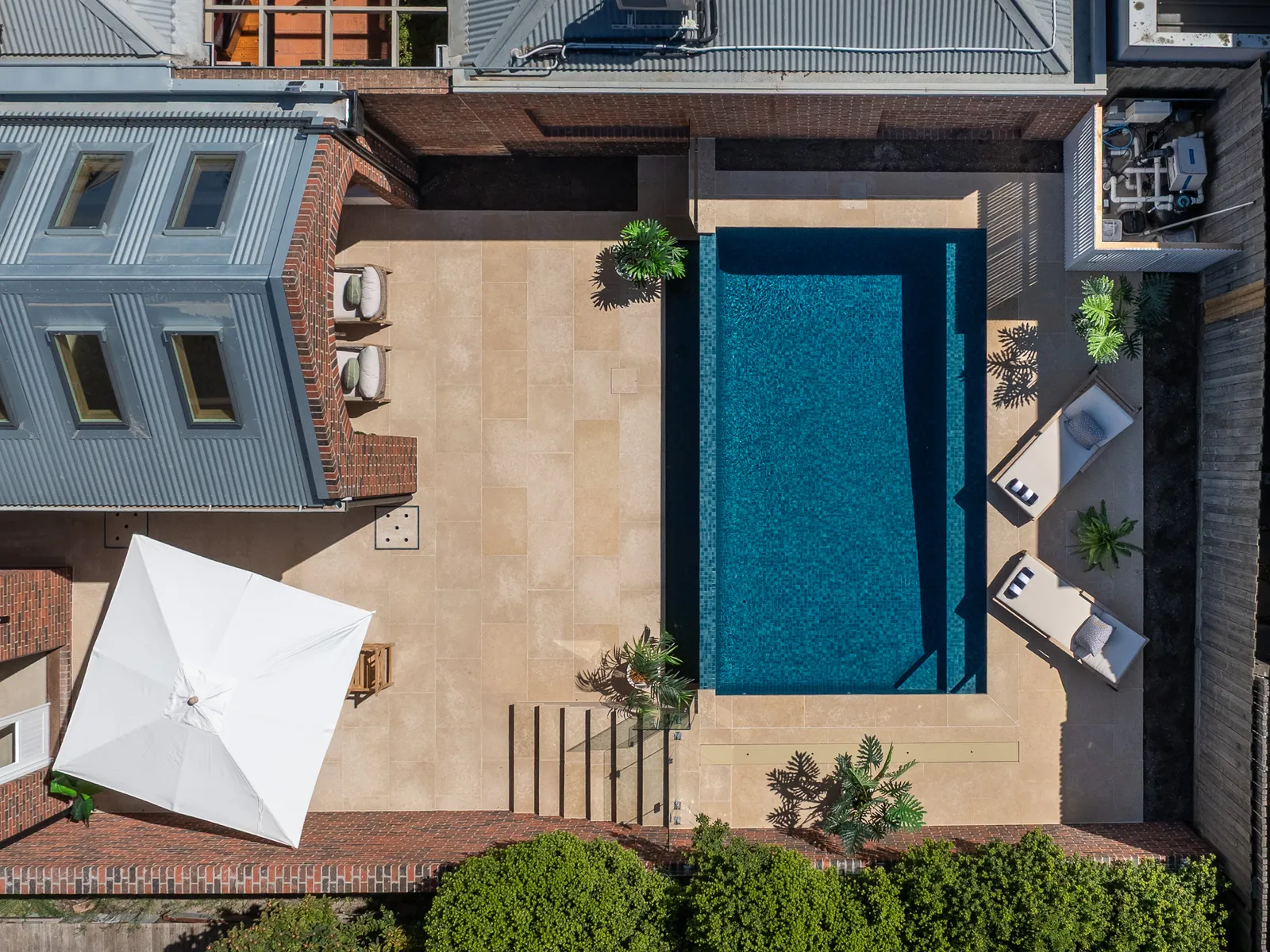 Aerial view of a completed pool and landscaped backyard at a custom build