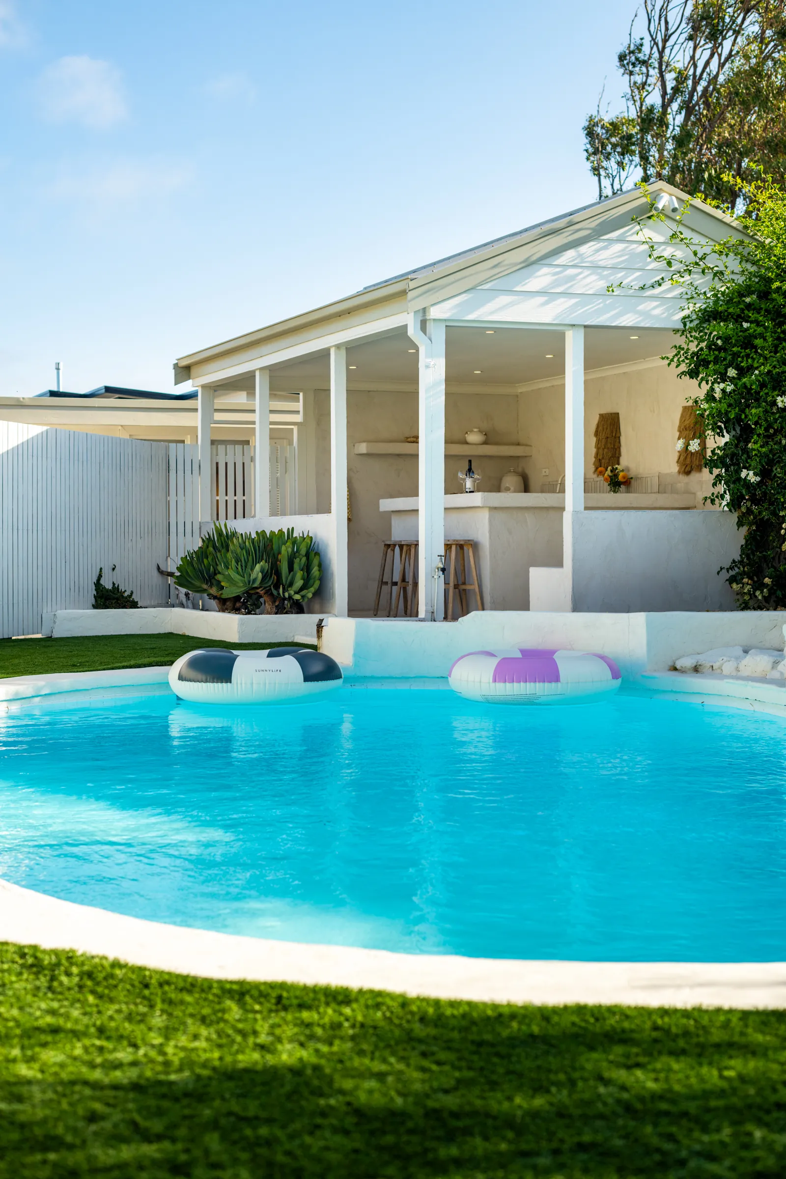 Poolside cabana and curved pool at dusk, Torquay